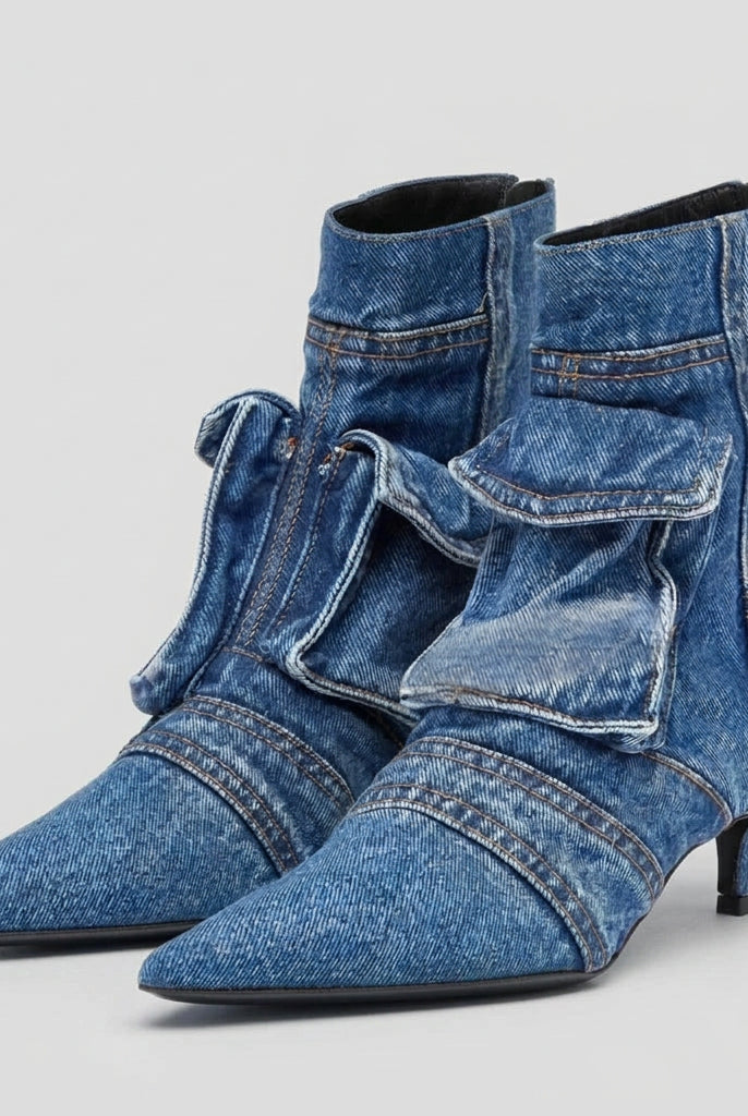 Blue denim high-heeled boots with a bow on a white background